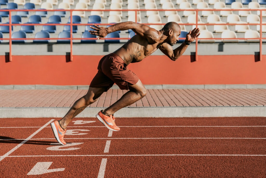 Athlete performing high-intensity sprint training on a track to stimulate mitochondrial biogenesis and cellular energy production