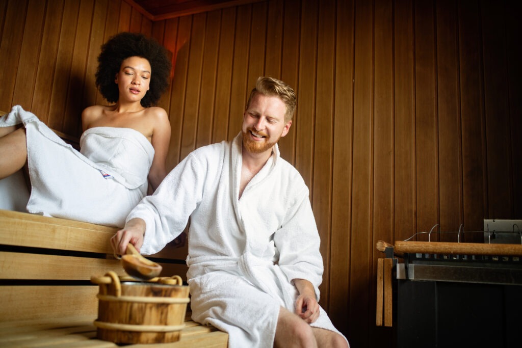 couple enjoying sauna activating hormetic stress pathways to support their mitochondria