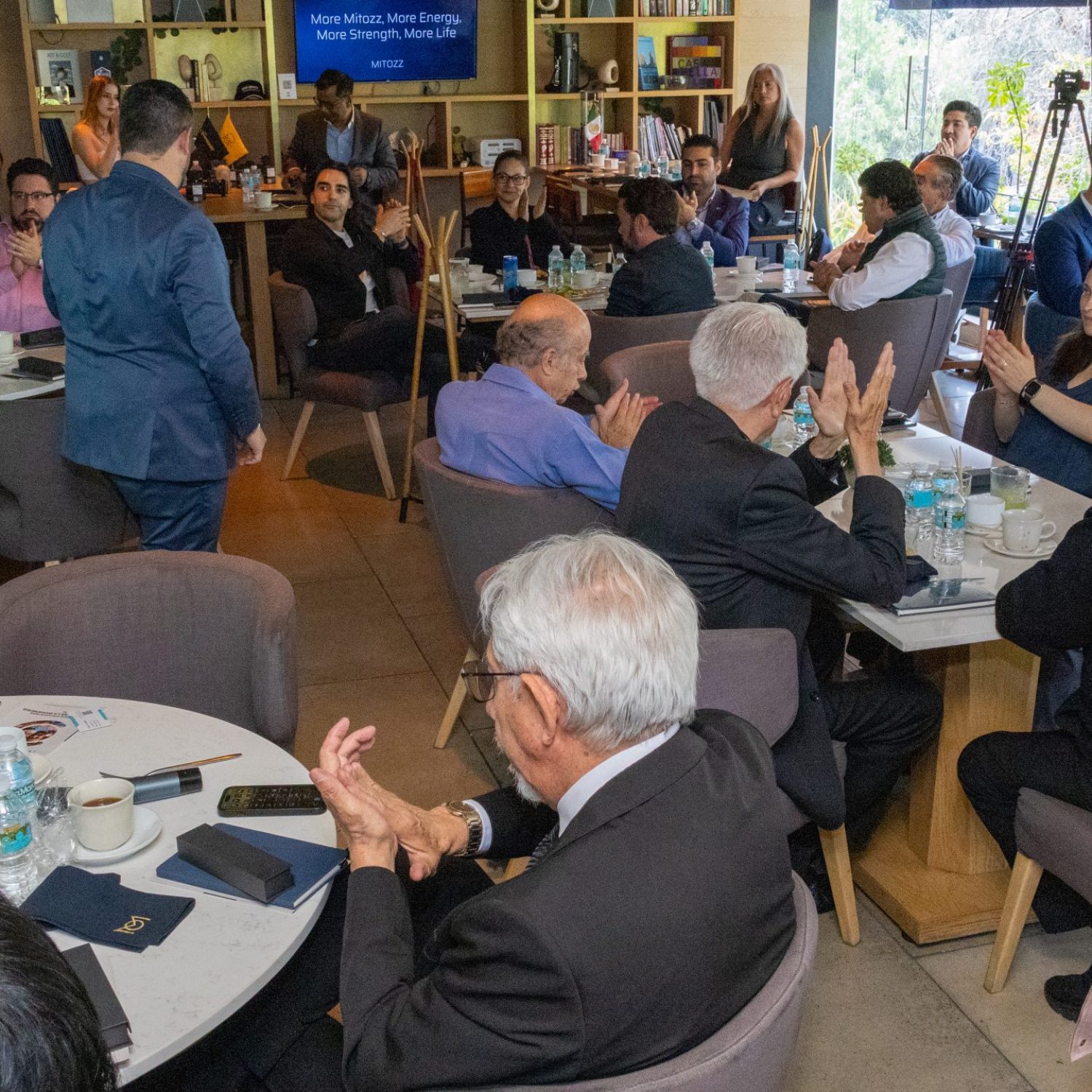 Attendees listening to a scientific presentation during Mitozz Events focused on mitochondrial health and wellness research.